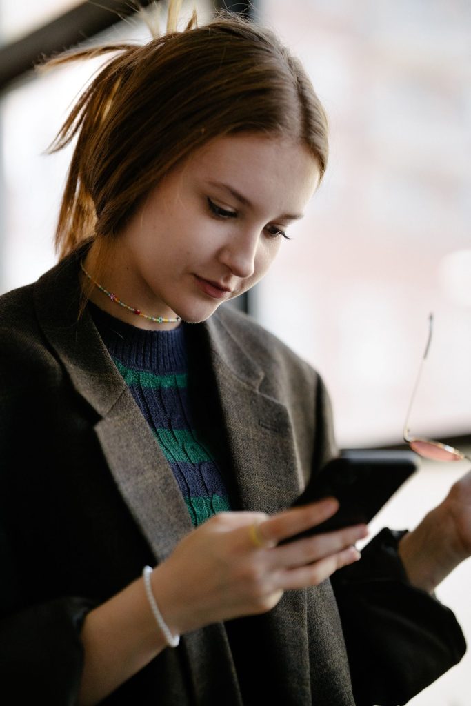 Woman checking her phone at a desk